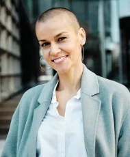 confident-business-woman-looking-camera-smile-while-standing-outside-office-buildings_513228-619